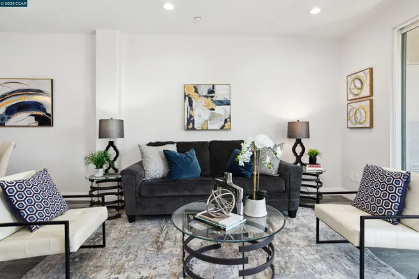 a living room with furniture fireplace and wooden floor