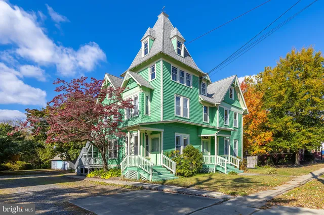 a view of a brick building next to a yard