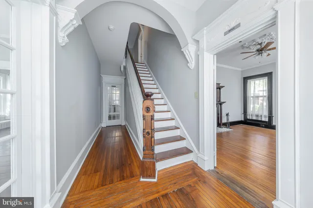 a view of a hallway with wooden floor and entryway