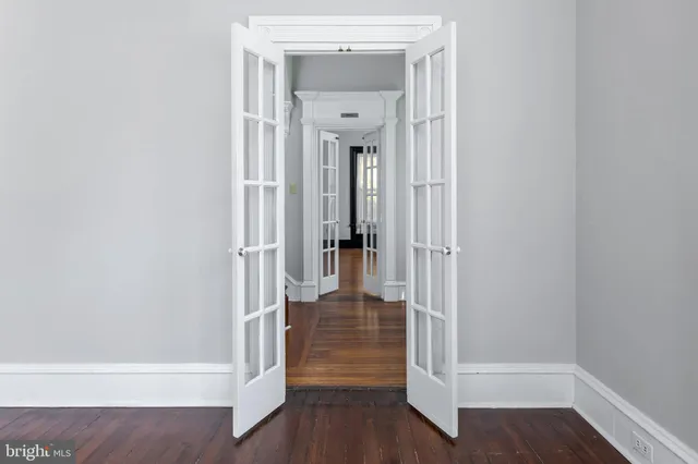 a view of a hallway with wooden floor and stairs