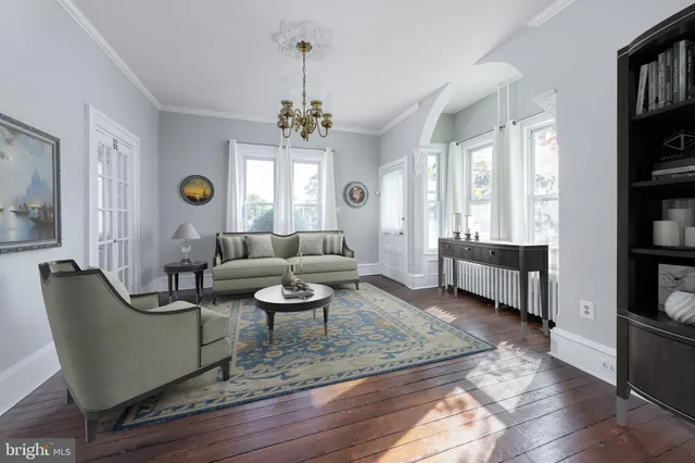 a living room with furniture and a chandelier