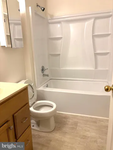 a bathroom with a toilet and a bathtub