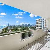 a view of a balcony with two chairs and a table