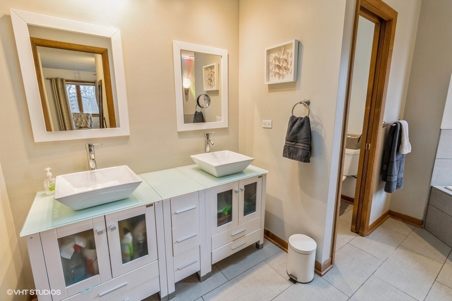 155 Forestview Drive Elgin, IL 60120 - Photo 17 of 36 a bathroom with a sink and a mirror