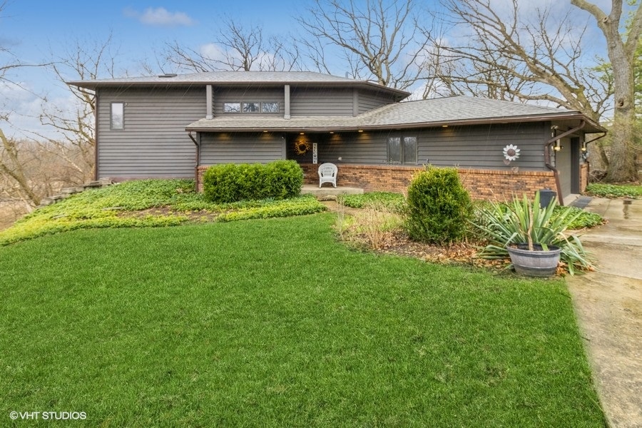 155 Forestview Drive Elgin, IL 60120 - Photo 2 of 36 a front view of a house with garden