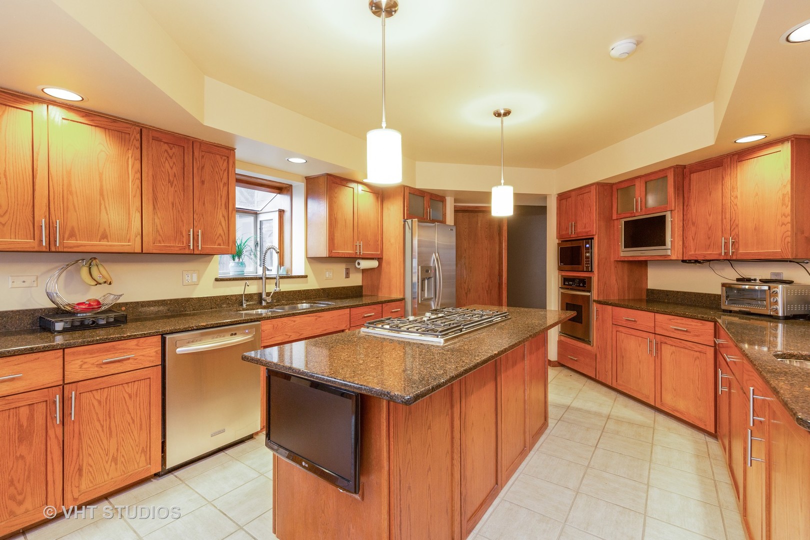155 Forestview Drive Elgin, IL 60120 - Photo 3 of 36 a kitchen with stainless steel appliances granite countertop wooden cabinets a sink and dishwasher