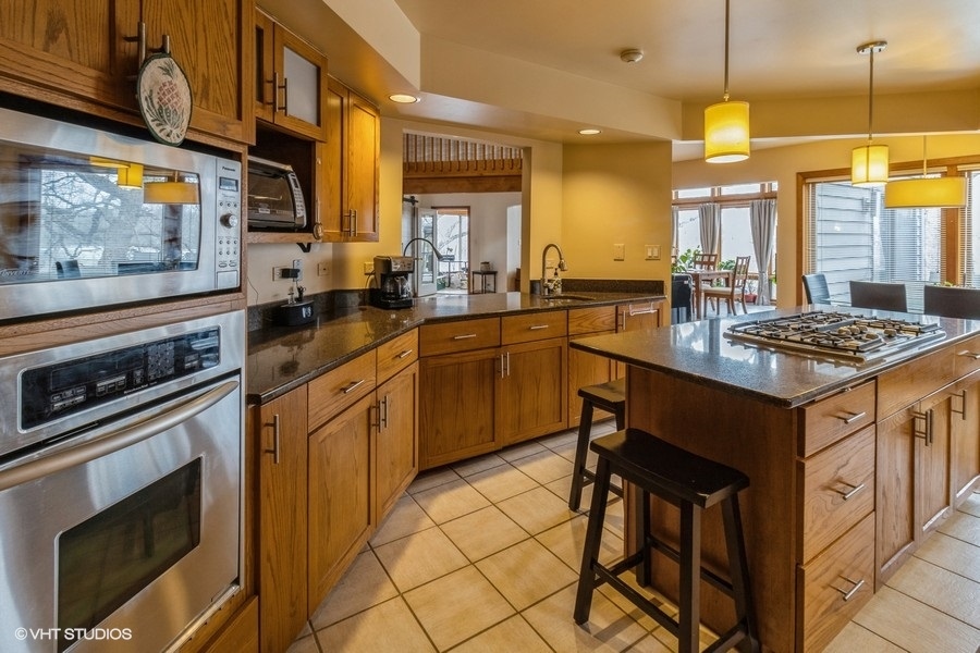 155 Forestview Drive Elgin, IL 60120 - Photo 7 of 36 a kitchen with a sink stove and cabinets