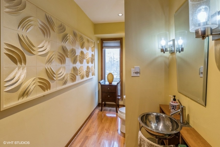 155 Forestview Drive Elgin, IL 60120 - Photo 10 of 36 a bathroom with a sink a toilet and mirror