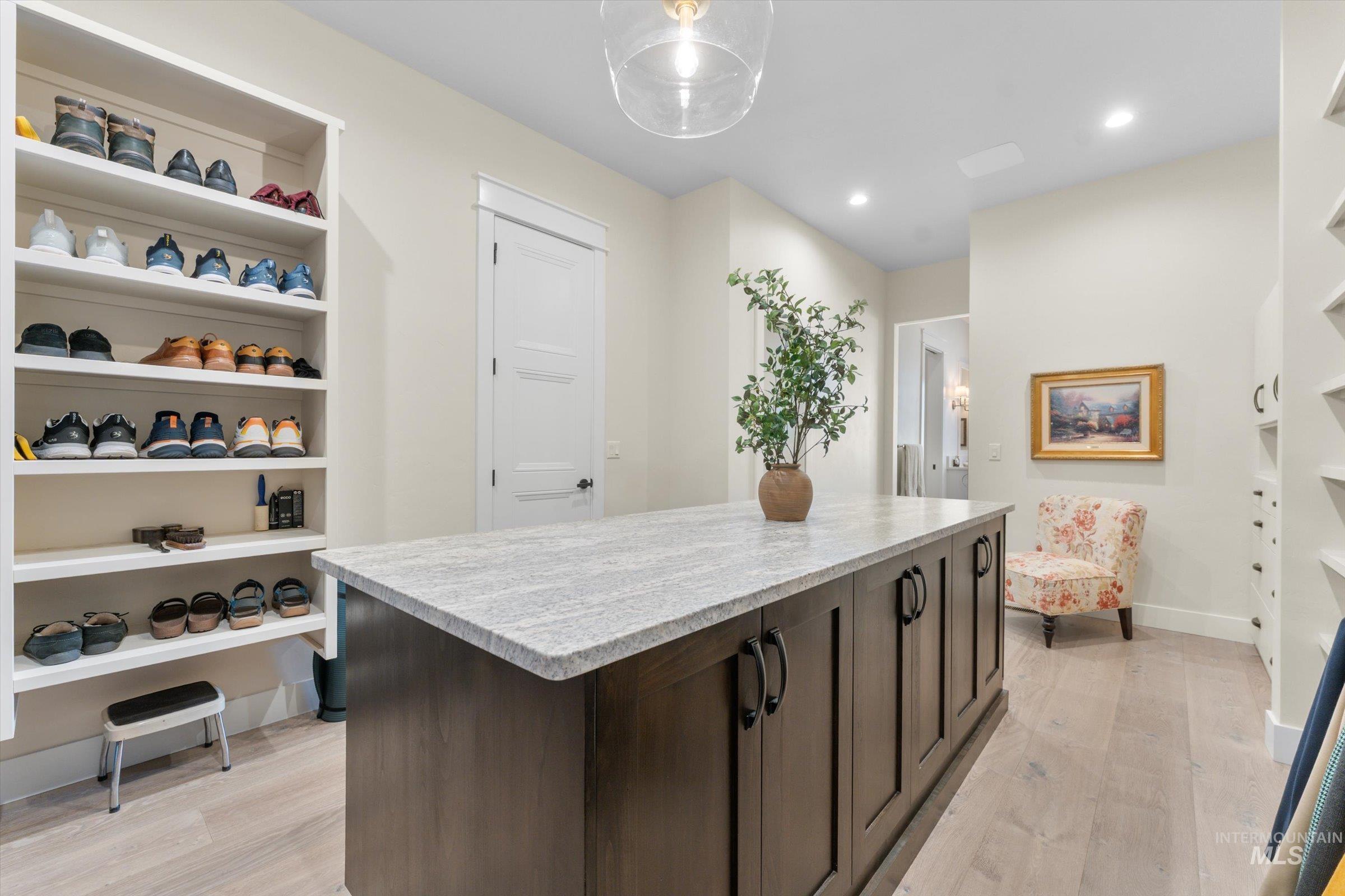 6585 South Pemberley Way Meridian, ID 83642 - Photo 28 of 43 Spacious custom closet featuring a large central island with a light-toned countertop and ample storage cabinetry