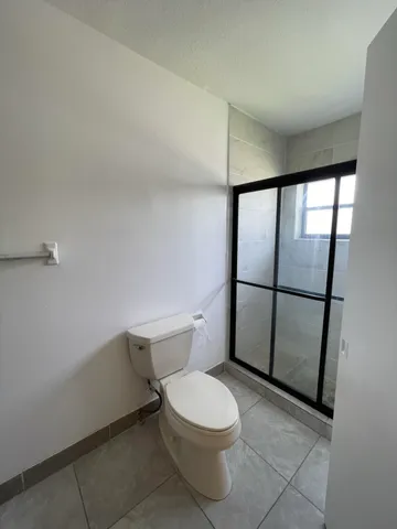 a white toilet sitting next to a bathroom sink