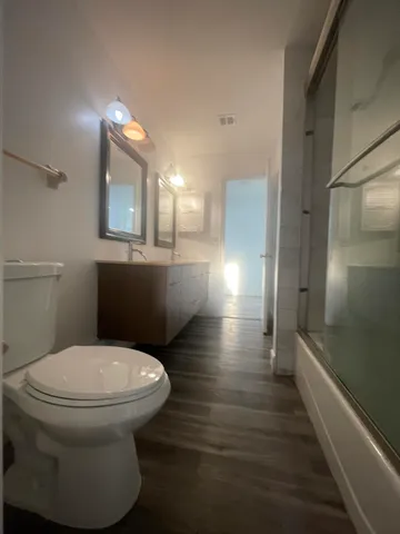 a bathroom with a toilet and a shower