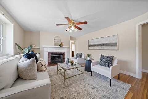 a living room with furniture and a fireplace