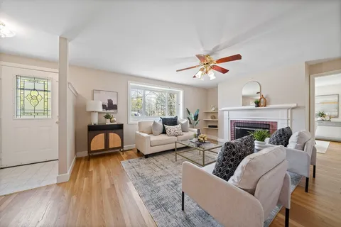 a living room with furniture and a fireplace