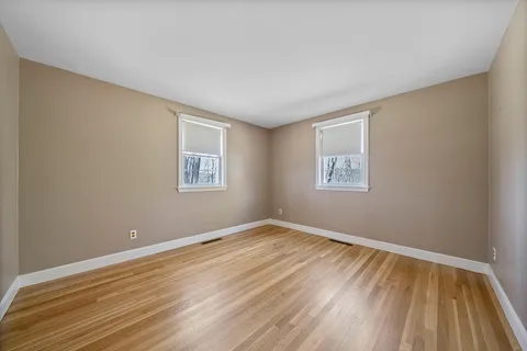 a view of room with window and wooden floor