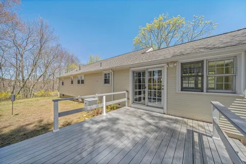 a view of a house with backyard and sitting area