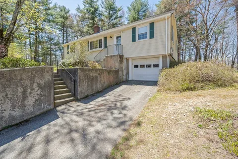 a view of a house with a wooden fence