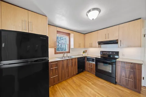 a kitchen with granite countertop stainless steel appliances and wooden cabinets