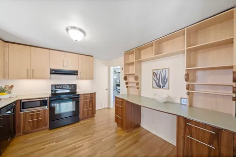 a kitchen with stainless steel appliances granite countertop a stove and a sink