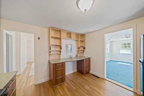 a view of kitchen and wooden floor