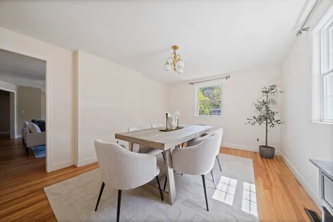 a view of a dining room with furniture window and wooden floor