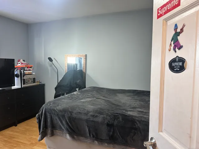 a bedroom with a bed and a bookshelf