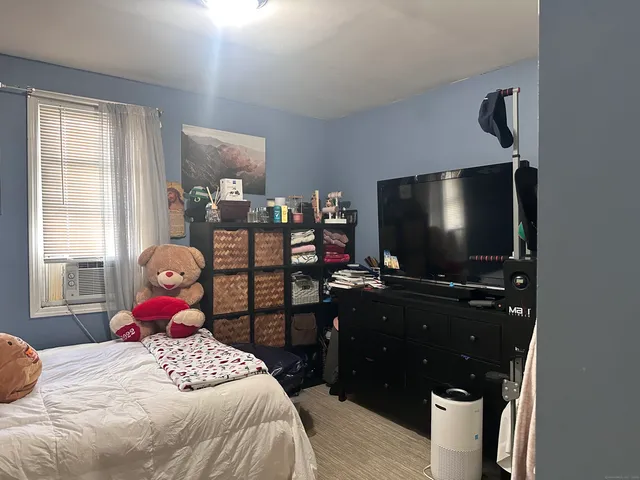 a bedroom with a bed and flat screen tv