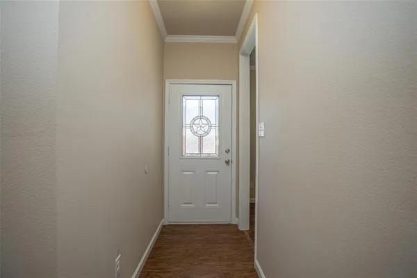 a view of a hallway with wooden floor