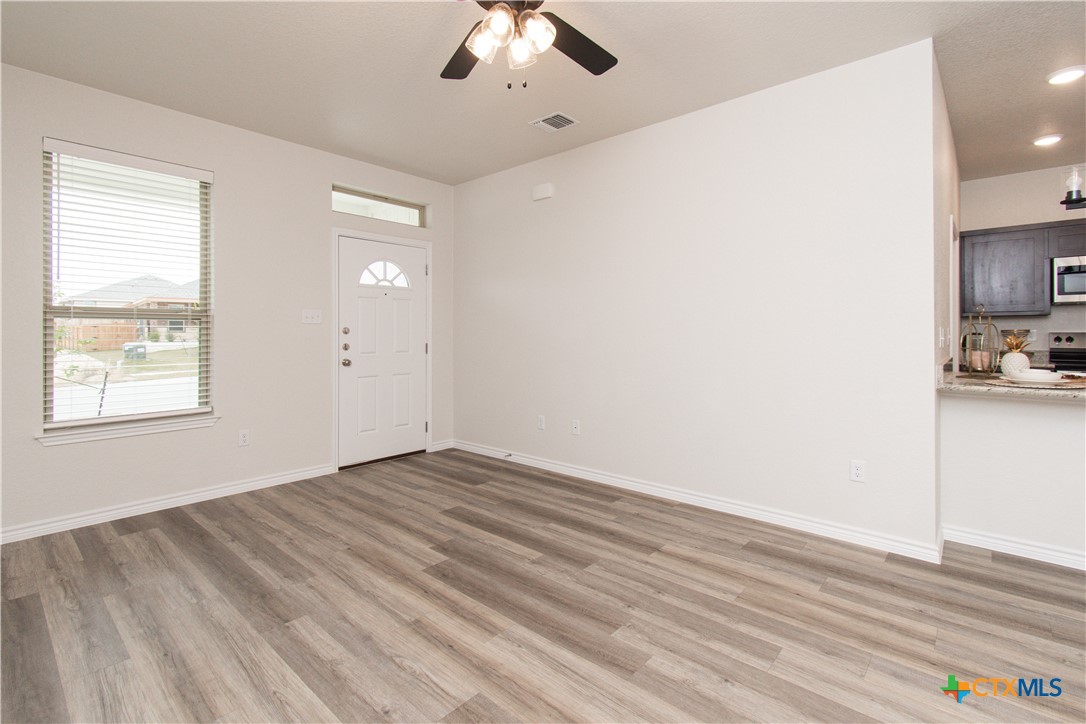 121 Leon Lane, Unit B Copperas Cove, TX 76522 - Photo 3 of 18 a view of empty room with wooden floor and fan
