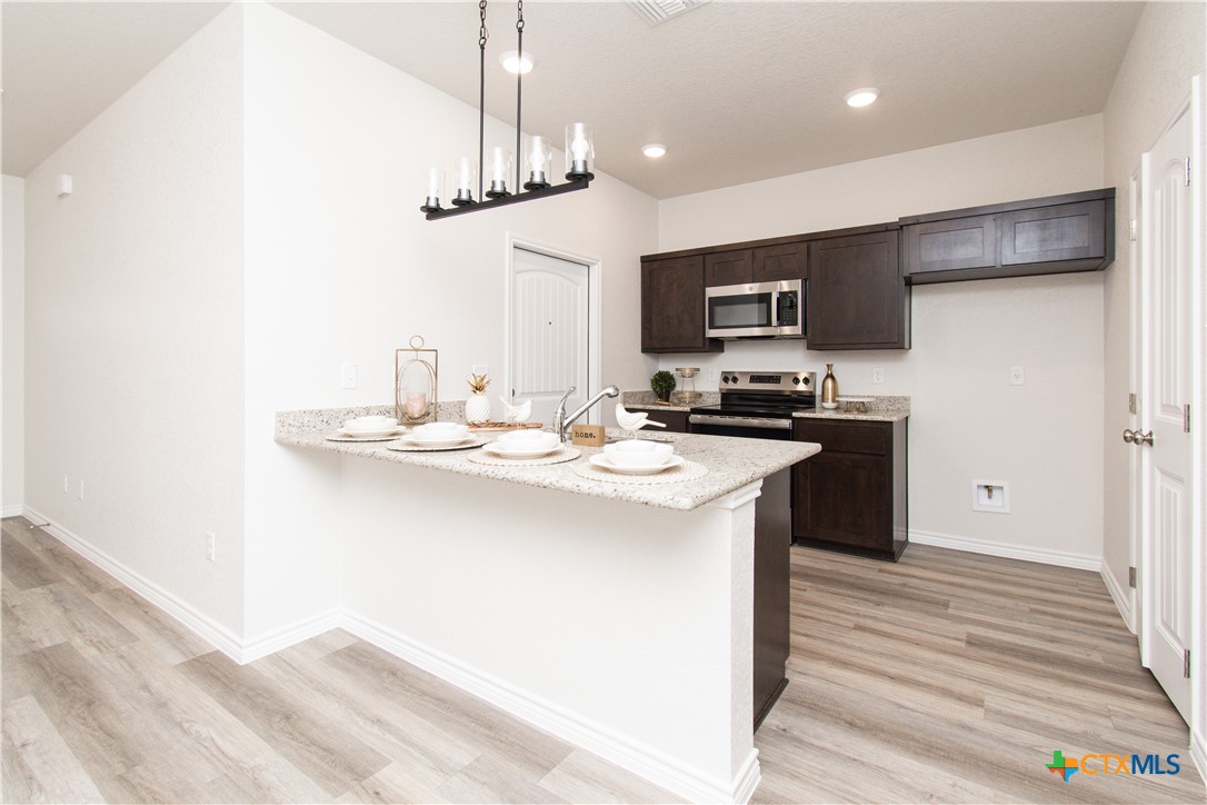 121 Leon Lane, Unit B Copperas Cove, TX 76522 - Photo 6 of 18 a kitchen with stainless steel appliances a sink stove and refrigerator