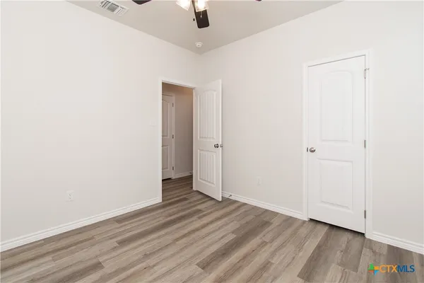 an empty room with wooden floor