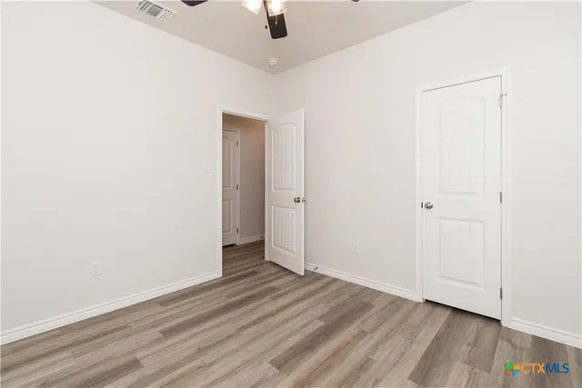 an empty room with wooden floor