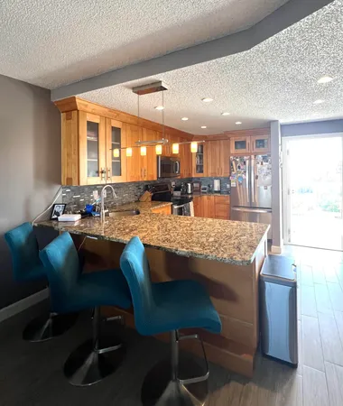 a large kitchen with a table and chairs