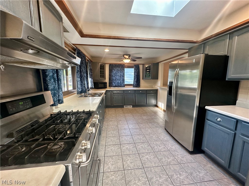 5855 Liberty Road Solon, OH 44139 - Photo 5 of 19 Kitchen featuring a skylight, appliances with stainless steel finishes, light tile patterned floors, and ceiling fan