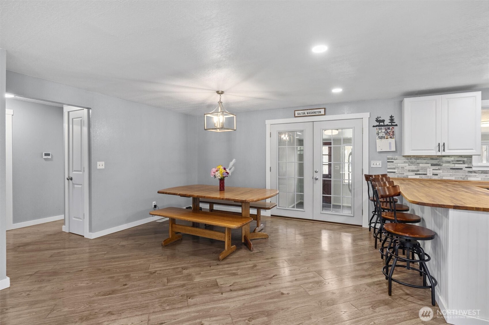 917 Dyer Road Sultan, WA 98294 - Photo 13 of 40 a living room with furniture a dining table and chandelier
