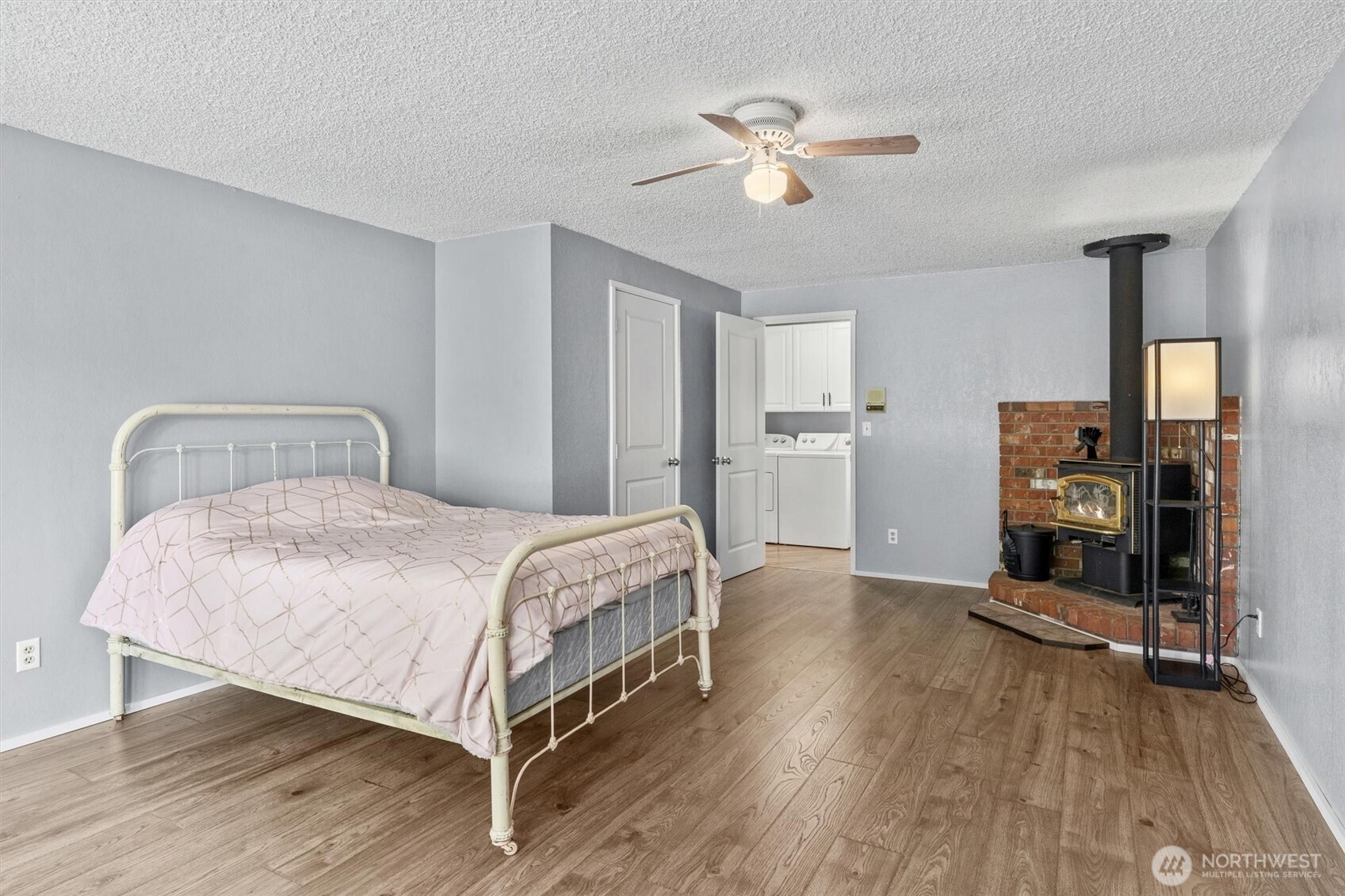 917 Dyer Road Sultan, WA 98294 - Photo 20 of 40 a bedroom with a bed and a chandelier