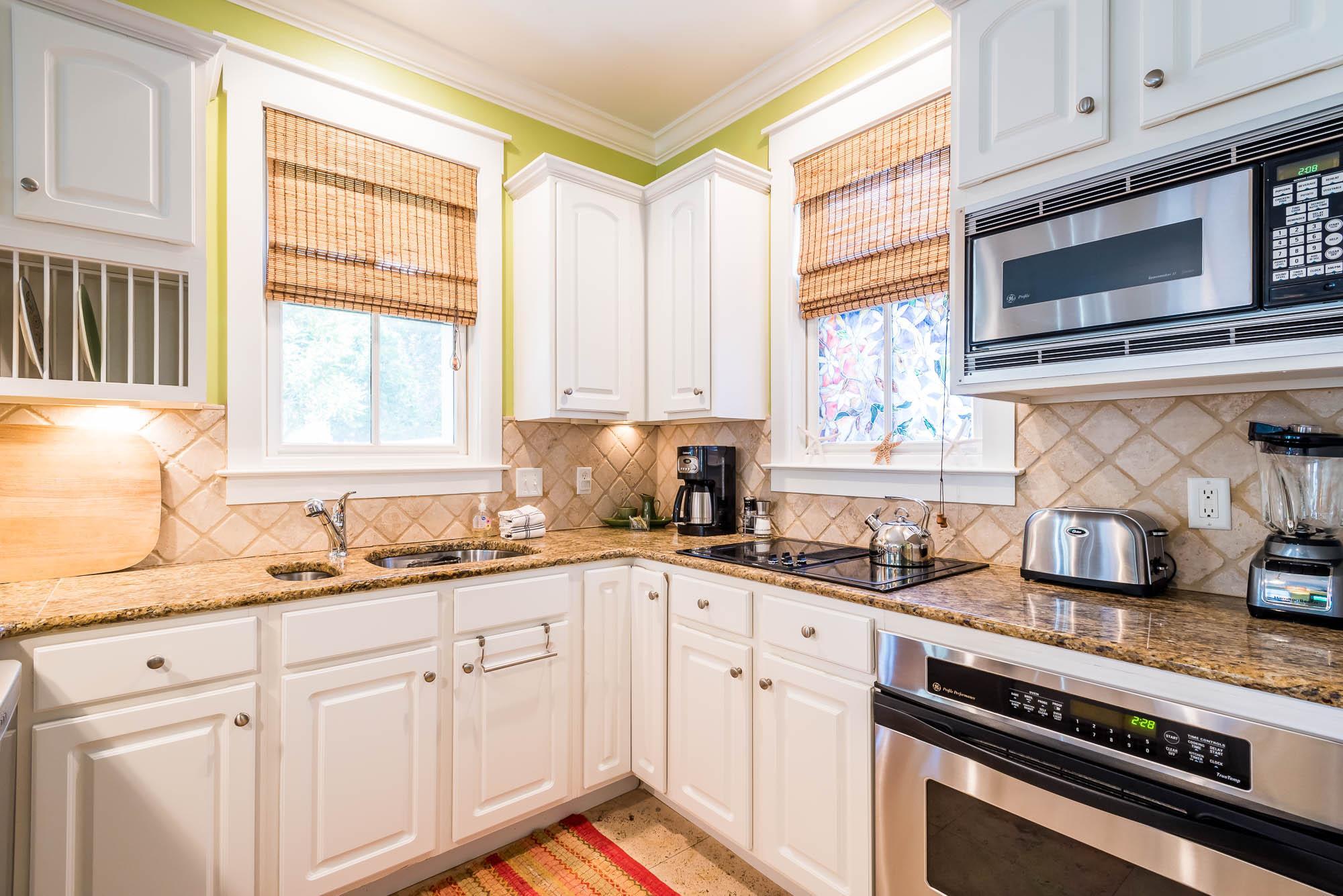 10140 East County Highway 30A, Unit 14 Inlet Beach, FL 32461 - Photo 6 of 14 a kitchen with stainless steel appliances granite countertop a sink a stove and cabinets