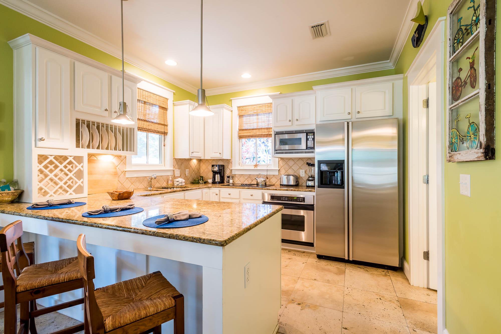 10140 East County Highway 30A, Unit 14 Inlet Beach, FL 32461 - Photo 7 of 14 a kitchen with a refrigerator a stove a sink and white cabinets with wooden floor