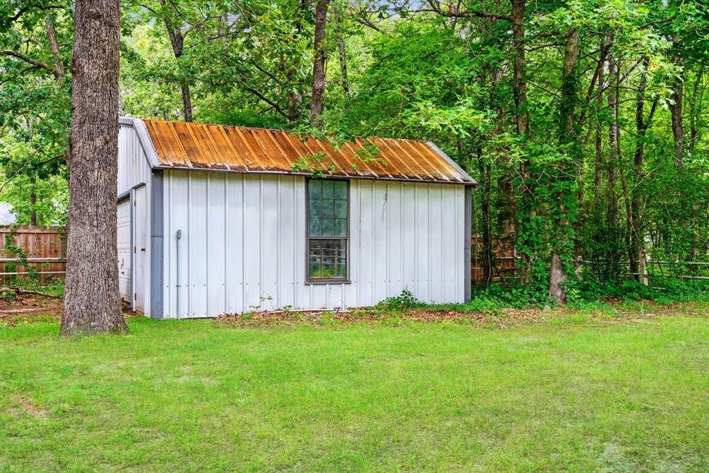 455 Timber Lakes Drive Powderly, TX 75473 - Photo 17 of 18 a backyard of a house with lots of green space