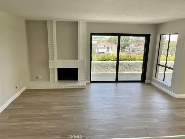 a view of room with window and wooden floor