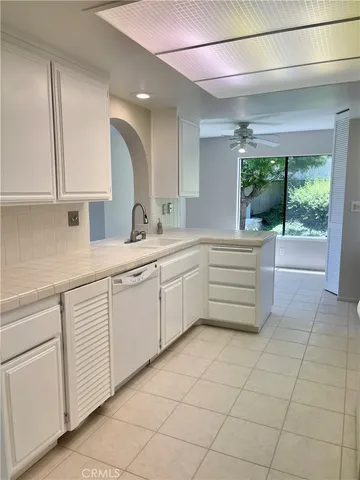 a kitchen with a sink a stove and cabinets