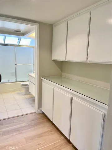 a view of an empty walk in closet with wooden floor