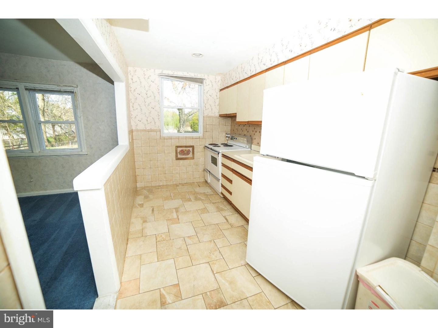 241 Barclay Road Upper Darby, PA 19082 - Photo 5 of 13 a open kitchen with a refrigerator and a stove