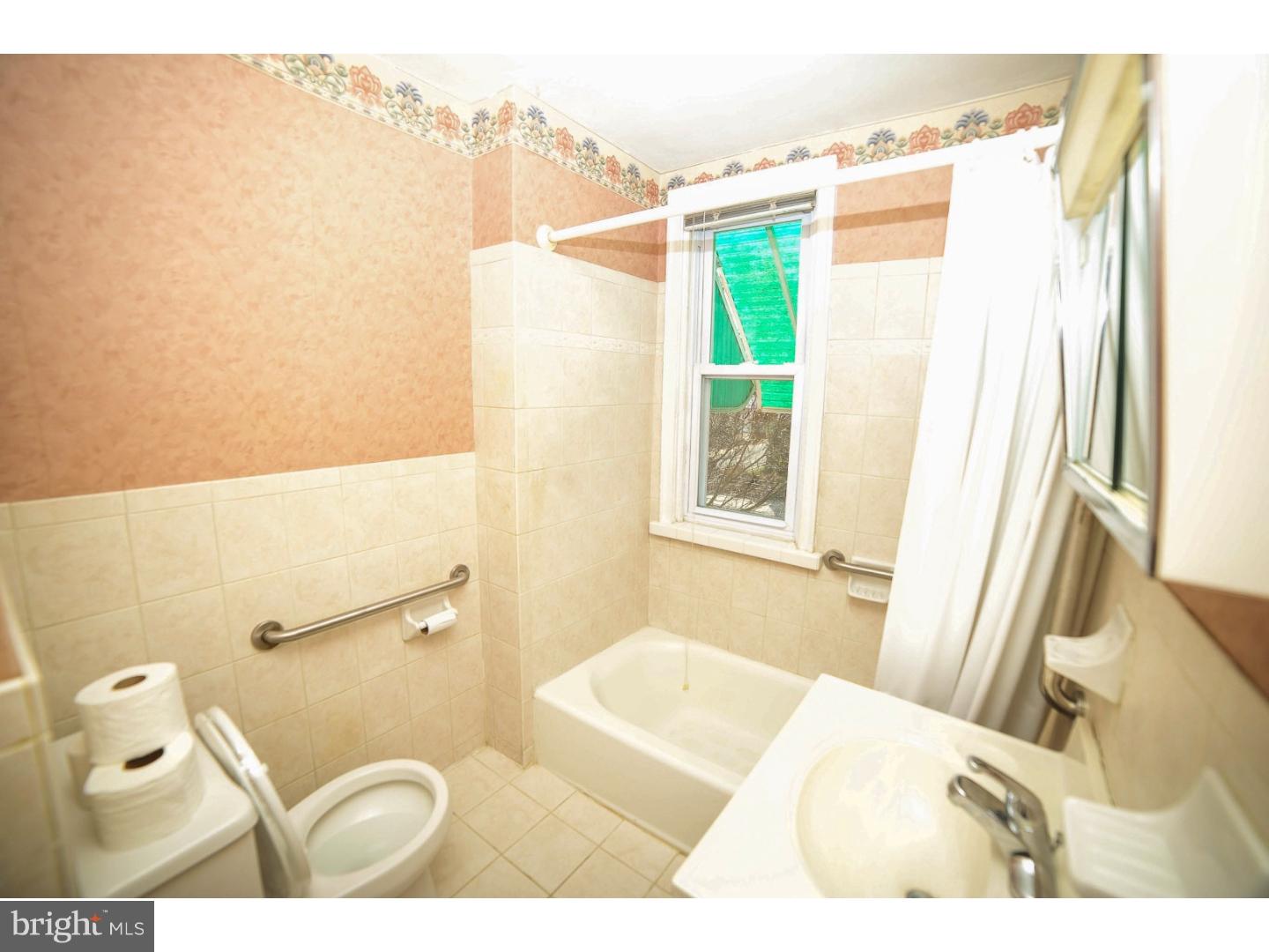 241 Barclay Road Upper Darby, PA 19082 - Photo 8 of 13 a bathroom with a sink and a shower curtain