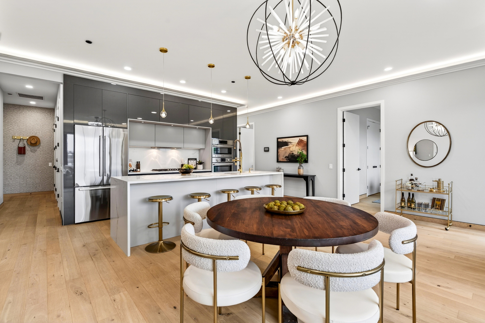 2024 West Irving Park Road, Unit 302 Chicago, IL 60618 - Photo 7 of 32 a kitchen with stainless steel appliances a table chairs and a chandelier
