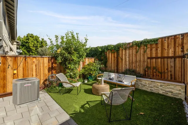 a backyard with chairs and a yard