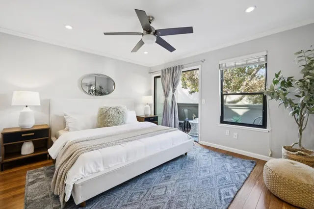 a bedroom with a bed and a large window