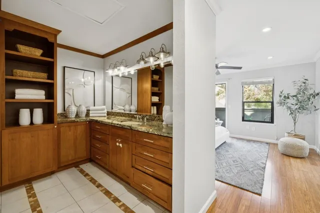 a spacious bathroom with a granite countertop sink a mirror and a