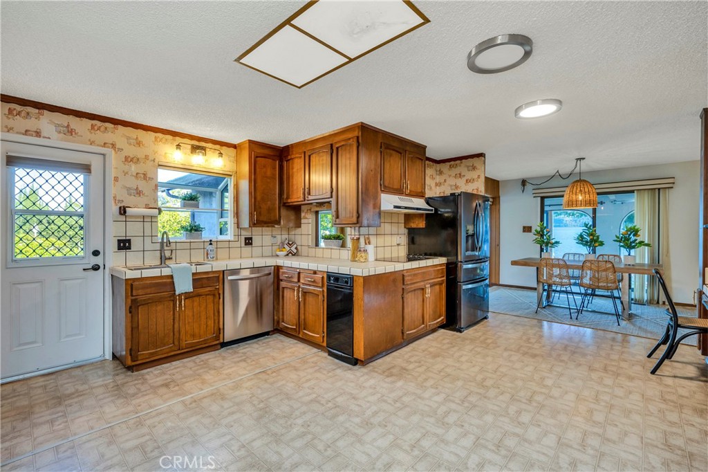 7723 Cora Drive Lucerne, CA 95458 - Photo 11 of 56 a kitchen with sink cabinets and window