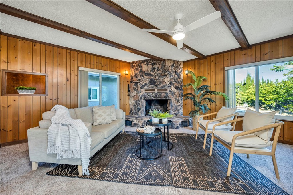 7723 Cora Drive Lucerne, CA 95458 - Photo 14 of 56 a living room with furniture a large window and a fireplace