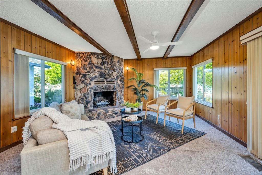 7723 Cora Drive Lucerne, CA 95458 - Photo 15 of 56 a living room with furniture a fireplace and a large window